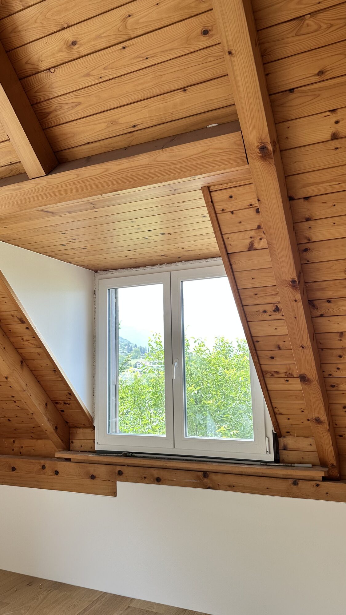 Fenêtre de toit sous charpente en bois
