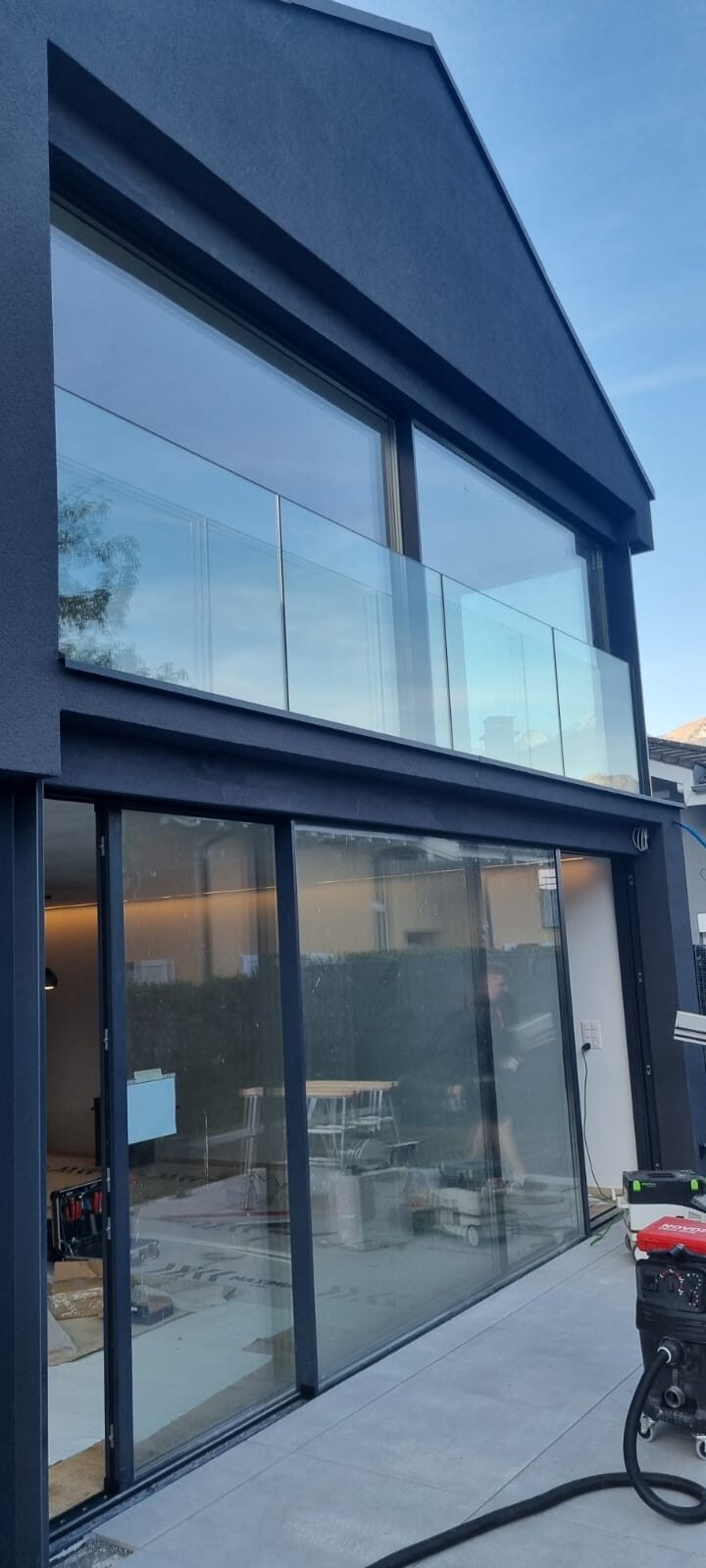 Façade contemporaine avec grandes baies et garde-corps en verre